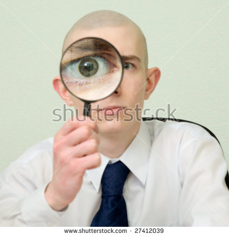 stock-photo-the-guy-looks-through-the-big-magnifier-27412039.jpg
